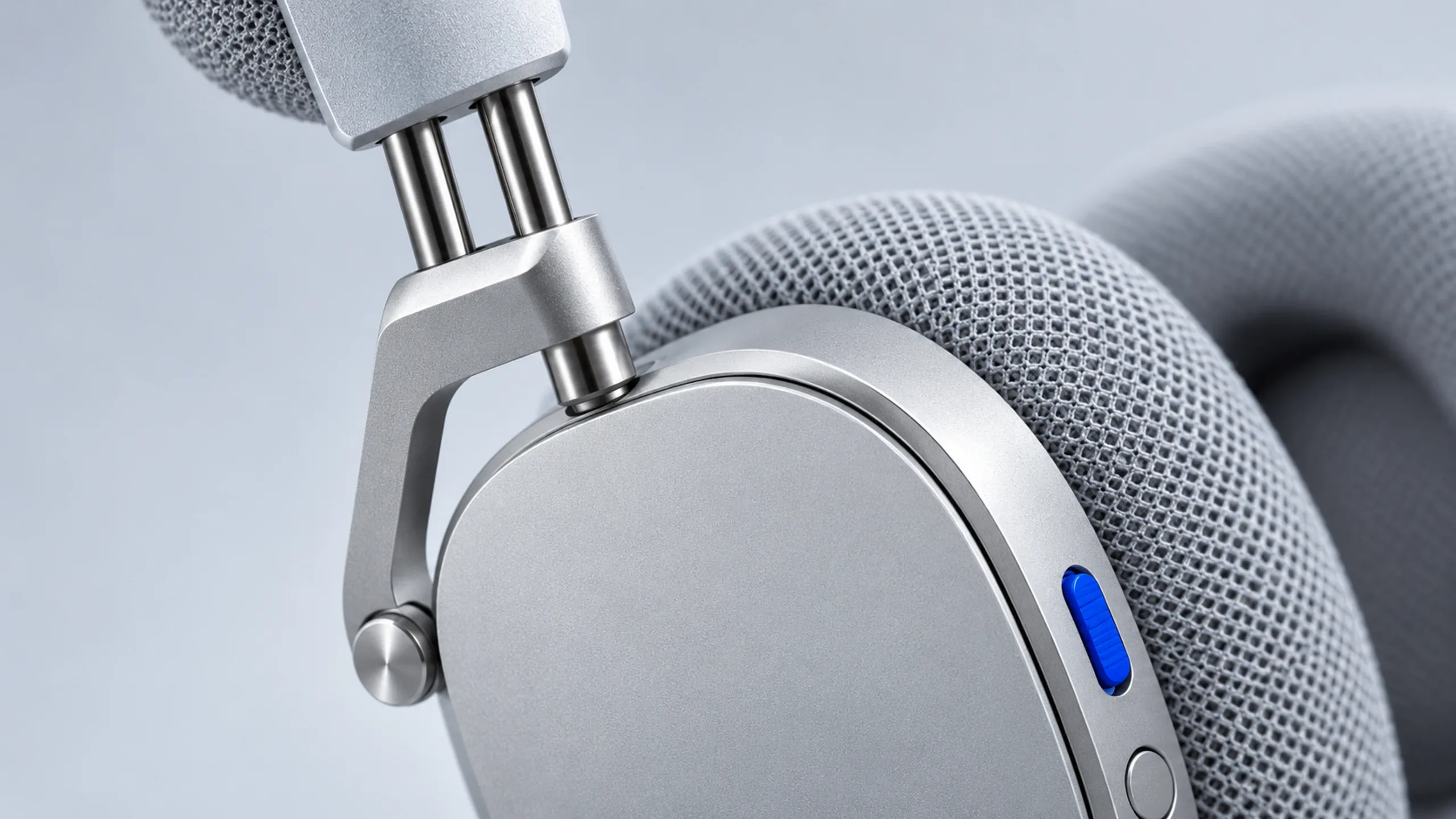 Aura One branded detail artwork: Aluminium wireless headphones on concrete in daylight