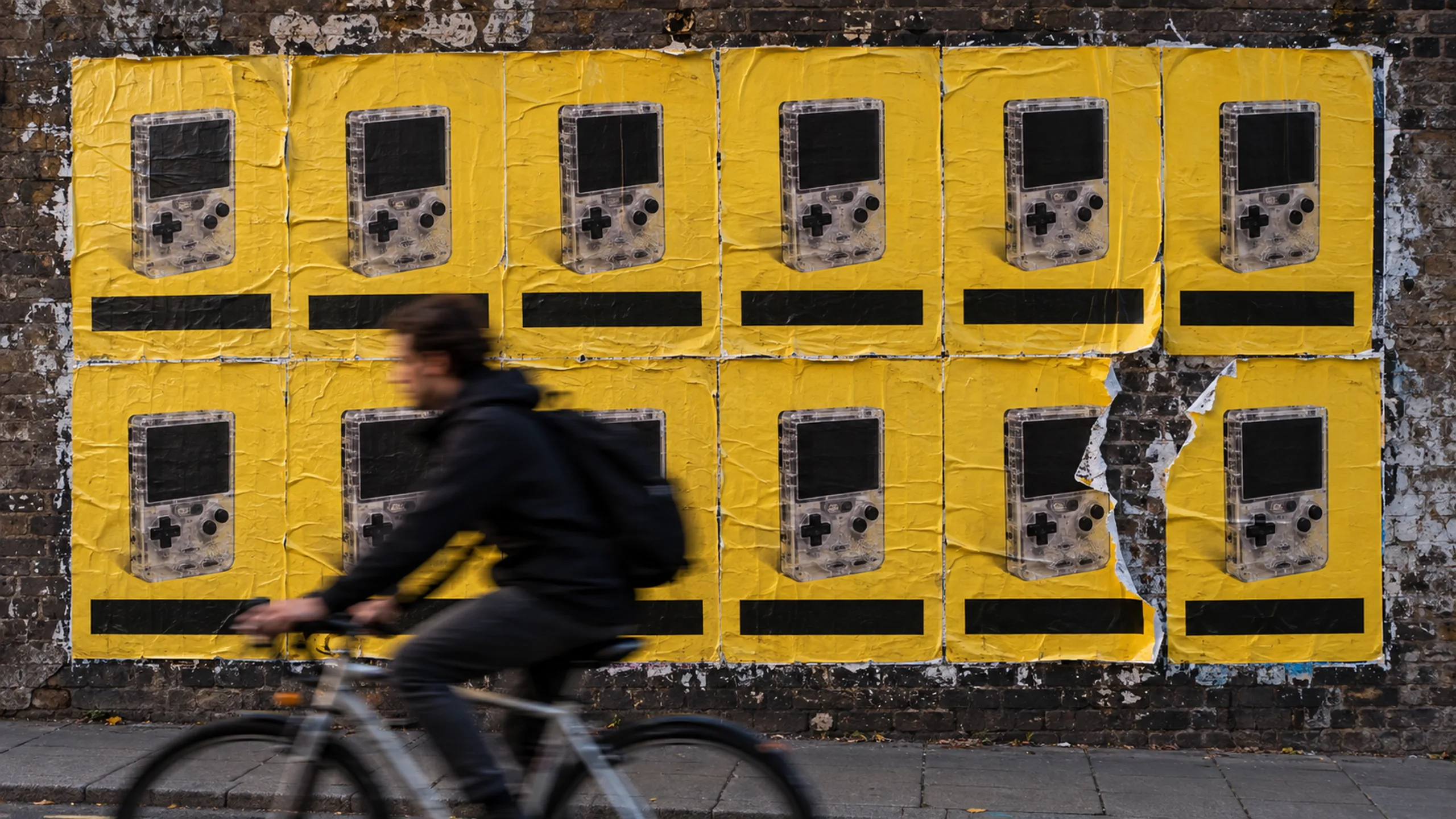 Buttern branded context artwork: A clear-plastic handheld console on butter yellow